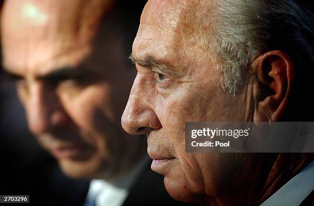 Israel's Labor party leader and former prime minister Shimon Peres and Defense Minister Shaul Mofaz attend an official memorial ceremony to mark the...