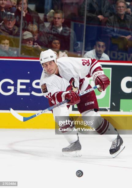 Cale Hulse of the Phoenix Coyotes passes the puck during the game against the Vancouver Canucks at General Motors Place on October 26, 2003 in...