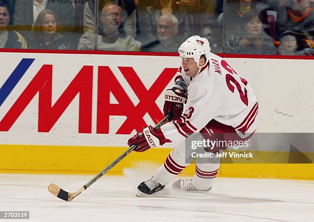 Paul Mara of the Phoenix Coyotes skates with the puck during the game against the Vancouver Canucks at General Motors Place on October 26, 2003 in...