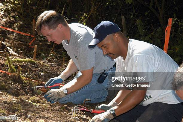 In this undated King County Prosecutor's Office handout photo, investigators search for the remains of one of Green River killer Gary Leon Ridgway...