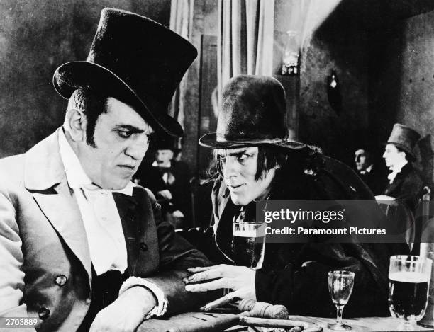 American actor John Barrymore , as Mr Hyde , touches the arm of an unidentified actor at a bar in a still from director John S. Robertson's film,...