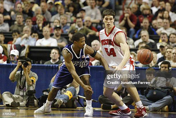 Jermain Boyette of the Weber State University Wildcats passes by Mike Wilkinson of the University of Wisconsin Badgers during the NCAA Tournament 1st...