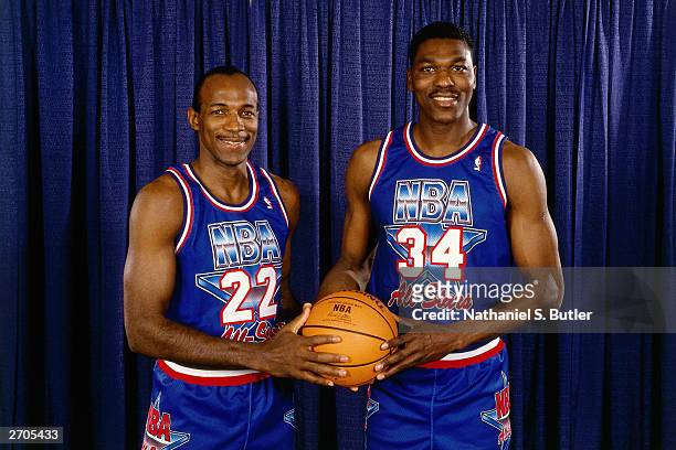 Clyde Drexler and Hakeem Olajuwon of the Western Conference All-Stars poses for a portrait during All-Star Weekend at the Orlando Arena circa 1992 in...