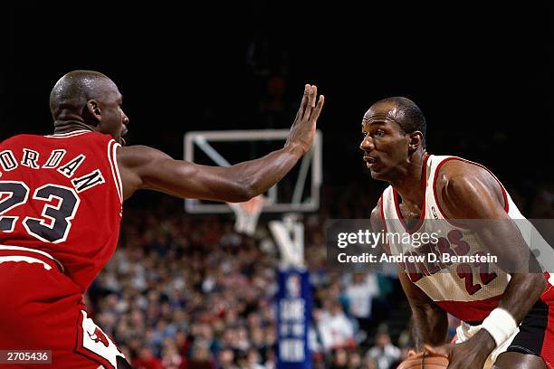 Clyde Drexler of the Portland Trail Blazers gets set to drives against the Michael Jordan of the Chicago Bulls circa 1993 during the NBA game at...