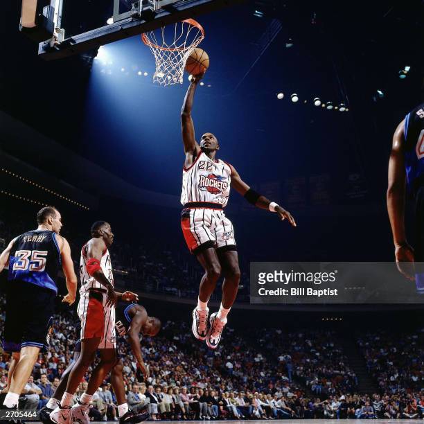 Clyde Drexler of the Houston Rockets goes up for a slam dunk against the Cleveland Cavaliers circa 1998 during the NBA game at The Summit in Houston,...