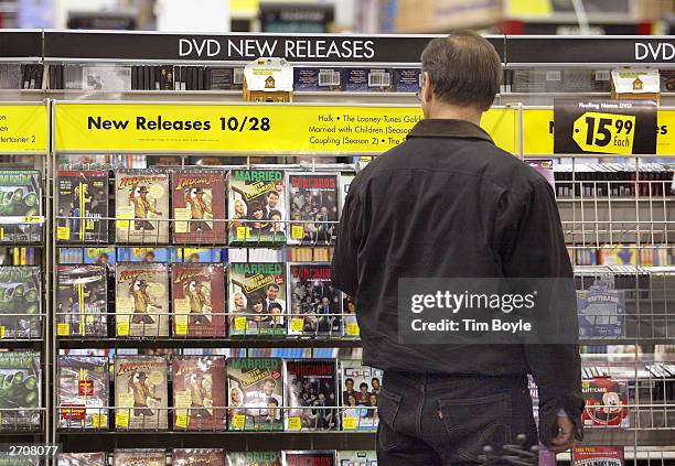 Shopper peruses newly released DVDs at a Best Buy store November 7, 2003 in Skokie, Illinois. The Bureau of Labor Statistics of the U.S. Department...