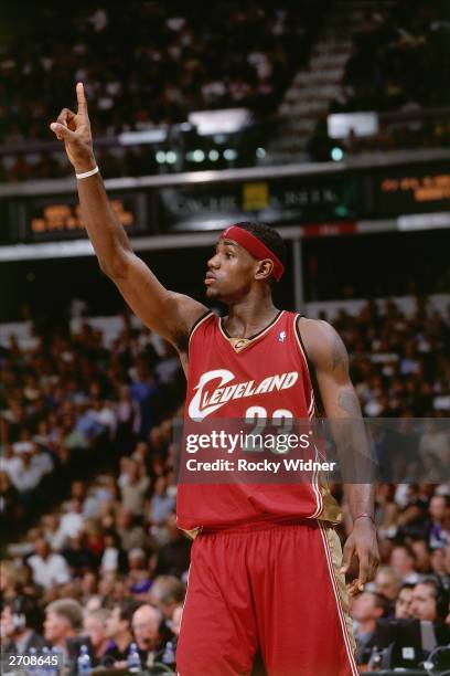 LeBron James of the Cleveland Cavaliers signals to teammates during a game against the Sacramento Kings at the Arco Arena on October 29, 2003 in...