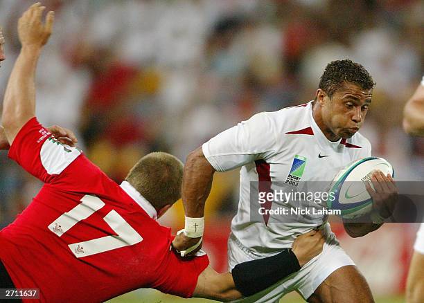 Jason Robinson of England breaks the diving tackle of Gethin Jenkins of Wales during the Rugby World Cup Quarter Final match between England and...