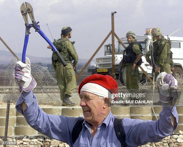 Protester holds a wire-cutter during a demonstration by foreign activists of the International Solidarity Movement and Palestinians near the...