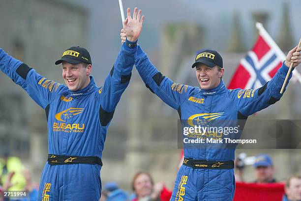 Subaru's Phil Mills and Petter Solberg celebrate after winning the World Rally Champiosnip and the Wales Rally GB at Margam Park on November 9, 2003...