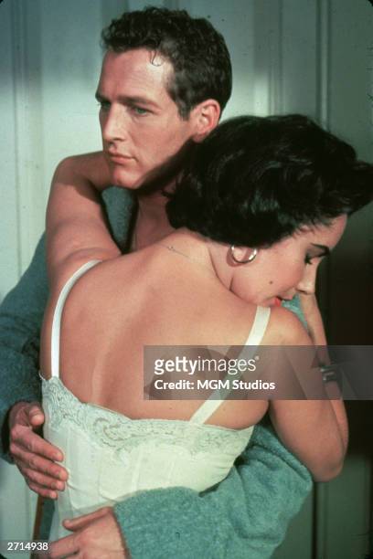 American actor Paul Newman and British-born actor Elizabeth Taylor embrace in a still from the film, 'Cat On A Hot Tin Roof', directed by Richard...