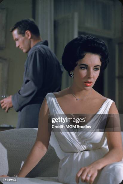 American actor Paul Newman and British-born actor Elizabeth Taylor have a conversation in a still from the film, 'Cat On A Hot Tin Roof', directed by...