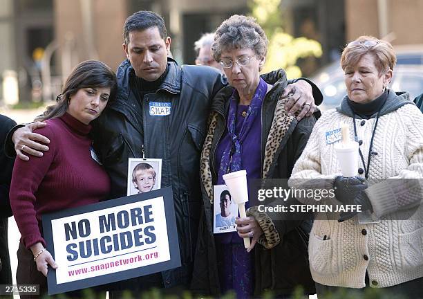 Nancy Sloan , Carlos Perez-Carrillo , Janet Patterson and Nora Connors who were all affected by clergy abuse, hold a vigil outside the hotel where...