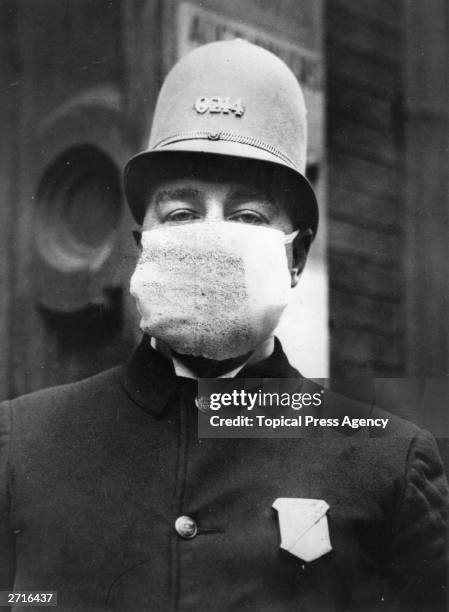 An American policeman wearing a 'Flu Mask' to protect himself from the outbreak of Spanish flu following World War I.