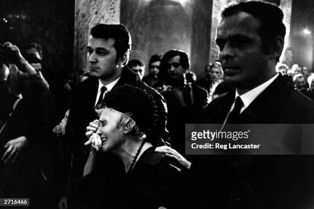 Woman weeping at a funeral for one of the victims of the fighting in Czechoslovakia.