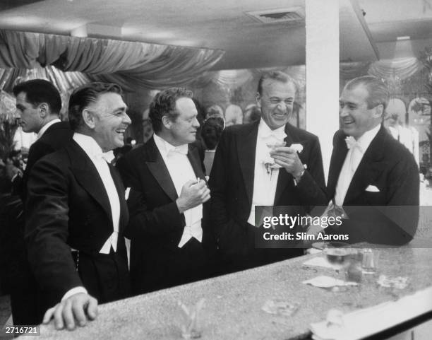 Premium Rates Apply. Film stars Clark Gable , Van Heflin , Gary Cooper and James Stewart enjoy a joke at a New Year's party held at Romanoff's in...