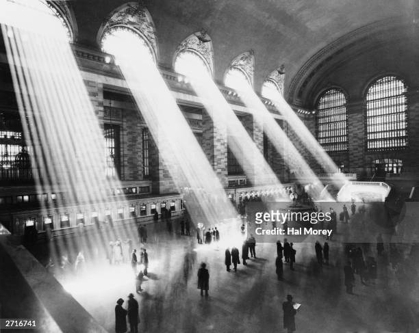 Beams of sunlight streaming through the windows at Grand Central Station, New York City, circa 1930.