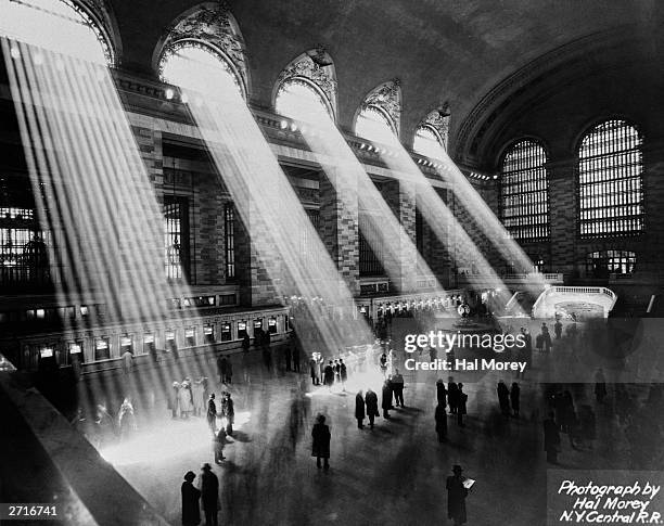 Beams of sunlight streaming through the windows at Grand Central Station, New York City, circa 1930.