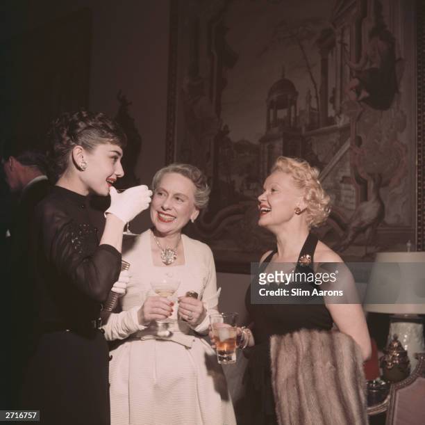 On the left film star Audrey Hepburn talks with Mrs Grover Magnin and another guest at a party in San Francisco.