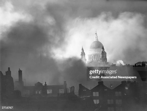 St Paul's cathedral standing above the surrounding burning buildings during the London blitz, 29th December 1940.