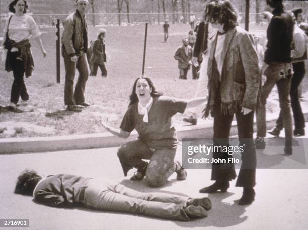 Teenager Mary Ann Vecchio screams as she kneels over the body of Kent State University student Jeffrey Miller who had been shot during an anti-war...