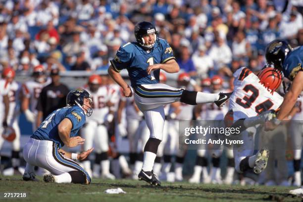 Place kicker Mike Hollis of the Jacksonville Jaguars kick from the hold by Bryan Barker during a NFL game against the Cincinnati Bengals at Alltel...