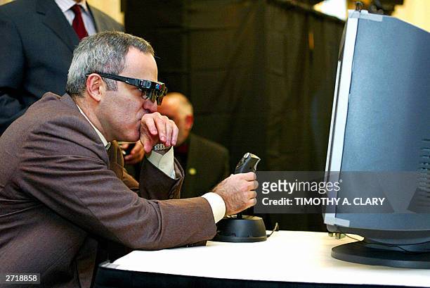Legendary chess champion, Garry Kasparov, wears his X3D viewing glasses as he makes his first move against the X3D Fritz computer program in the "X3D...
