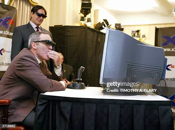 Legendary chess champion, Garry Kasparov, wears his X3D viewing glasses as he thinks of his next move against the X3D Fritz computer program in the...