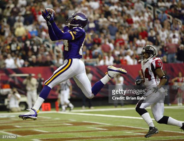 Wide receiver Randy Moss of the Minnesota Vikings goes up to get a touchdown pass over his head against cornerback Ray Buchanan of the Atlanta...