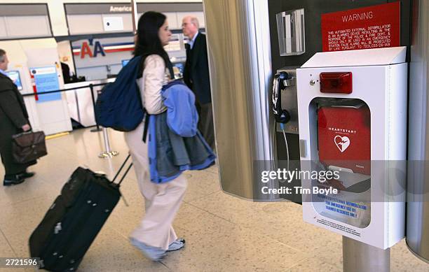 Travelers pass an Automated External Defibrillator in Terminal 3 November 12, 2003 at O'Hare International Airport in Chicago. An Automated External...
