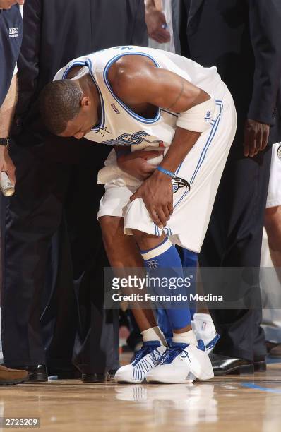 Tracy McGrady of the Orlando Magic holds his knee after hurting it against the Memphis Grizzlies during a game at TD Waterhouse Centre on November...