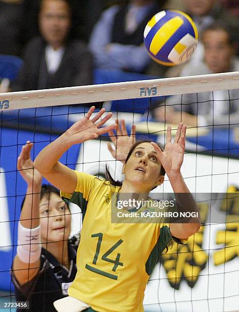 Brazilan captain Fernanda Venturini tosses the ball while Japanese defender Sachiko Sugiyama looks on during the World Cup women's volleyball...