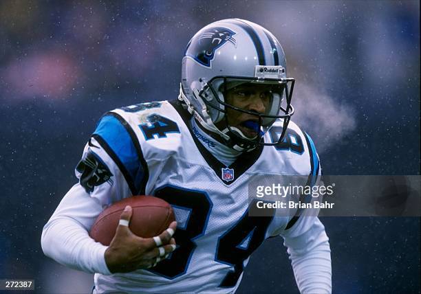 Wide receiver Rae Carruth of the Carolina Panthers moves the ball during a game against the Denver Broncos at Mile High Stadium in Denver, Colorado....