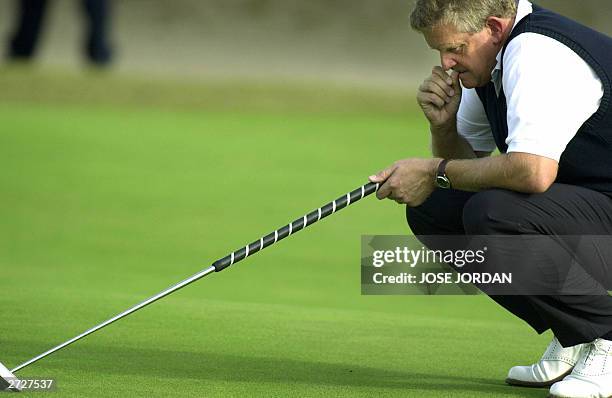 Scotland's Colin Montgomerie thinks prior to putting on the third day of the Seve Trophy 2003 at the EL Saler golf club in Valencia, 08 November...