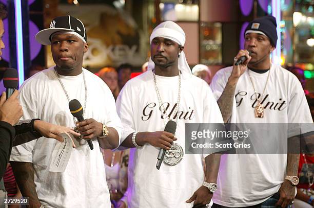 Cent and G-Unit appear onstage during "Spankin' New Music Week" on MTV's Total Request Live at the MTV Times Square Studios November 13, 2003 in New...