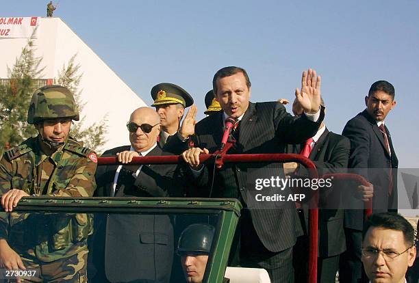 Turkish Prime Minister Recep Tayyip Erdogan addresses the crowd while parading with Turkish Cypriot leader Rauf Denktash during ceremonies marking...