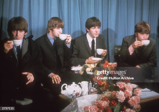 George Harrison , Ringo Starr, Paul McCartney and John Lennon of The Beatles at a press conference at London Airport, 2nd July 1964, following a tour...