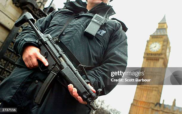 An armed British police officer stands gaurd outside the Houses of Parliament on November 17, 2003 in London. The unprecedented policing operation...