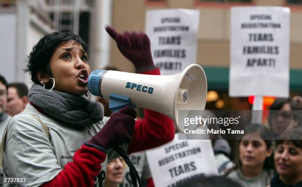 Suman Raghunathan, of the New York Immigration Coalition, yells during a protest marking the anniversary of the Immigration and Naturalization...