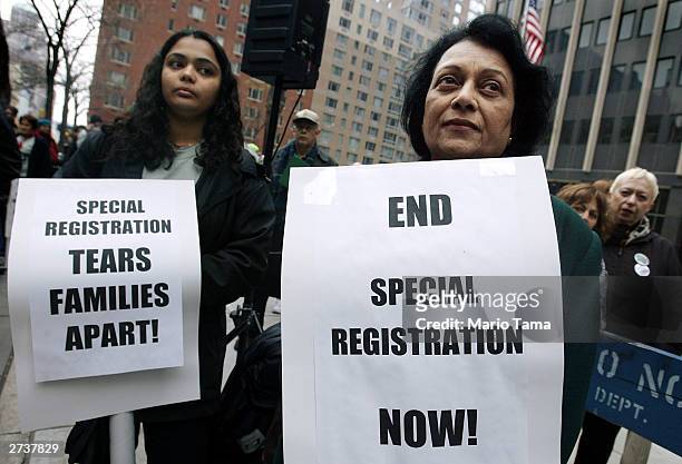 Sudha Acatarya and a woman who did not want to be identified attend a protest marking the anniversary of the Immigration and Naturalization Service's...