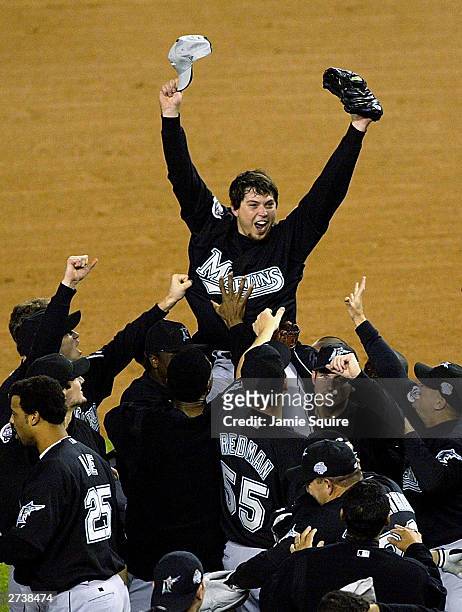 The Florida Marlins hoist up pitcher Josh Beckett the 2003 World Series MVP after defeating the New York Yankees 2-0 in game six of the Major League...