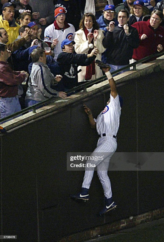 Fans interfere with catch by Alou