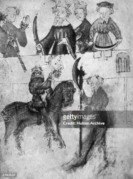 The Green Knight shows his severed head to King Arthur in an illustration depicting a scene from the fourteenth century legend of Gawain And The...