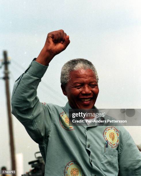 Nelson Mandela acknowledges a crowd of ANC supporters April 21, 1994 at a pre-election rally in Durban days before the historic democratic election...