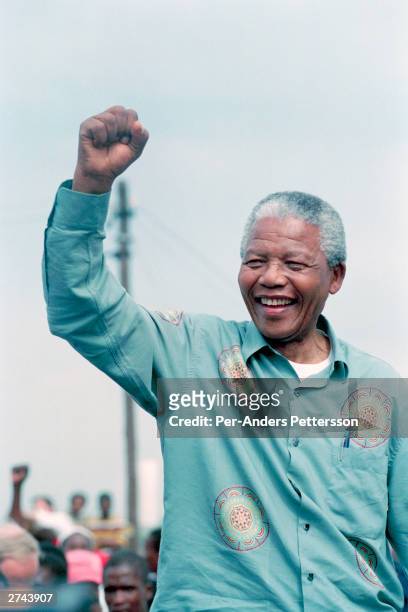 Nelson Mandela acknowledges a crowd of ANC supporters April 21, 1994 at a pre-election rally in Durban days before the historic democratic election...