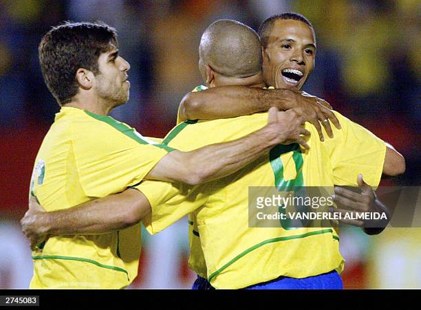 Brazilian striker Ronaldo Nazario celebrates his second goal, third of Brazil against Uruguay with teammates Juninho Pernambucano and Luiz Fabiano 19...