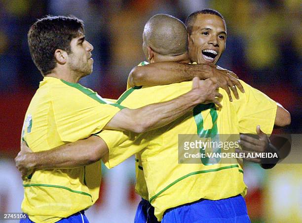 Brazilian striker Ronaldo Nazario celebrates his second goal, third of Brazil against Uruguay with teammates Juninho Pernambucano and Luiz Fabiano 19...