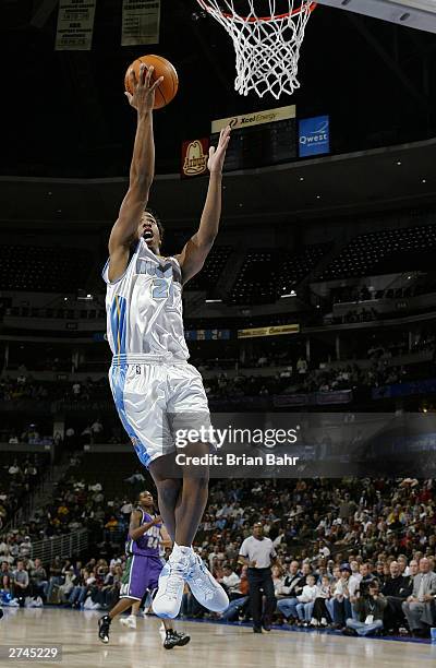 Andre Miller of the Denver Nuggets attempts a layup against the Milwaukee Bucks in the second quarter November 19, 2003 at the Pepsi Center in...