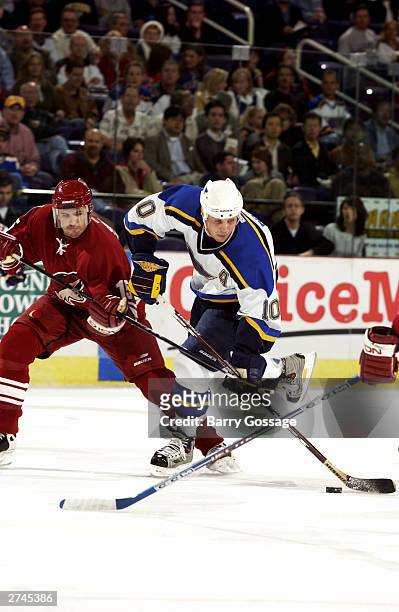 Dallas Drake of the St. Louis Blues skates with puck against the Phoenix Coyotes on November 19, 2003 at America West Arena in Phoenix, Arizona. The...