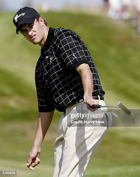 International Team member Adam Scott of Australia reacts to his putt on the 7th hole during the first round of the Presidents Cup at The Links at...